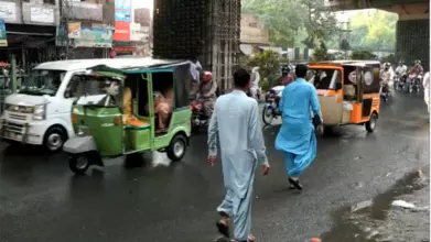People walking on busy road in Pakistan