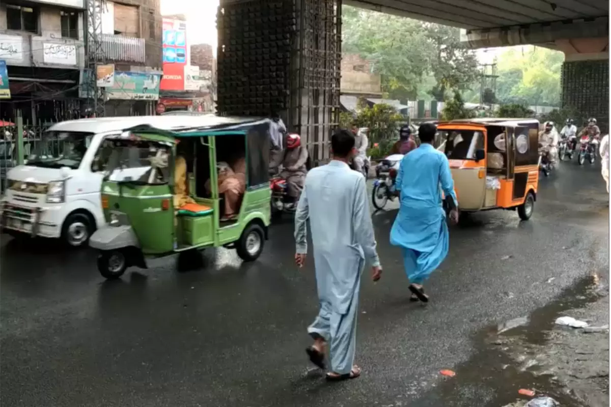 People walking on busy road in Pakistan